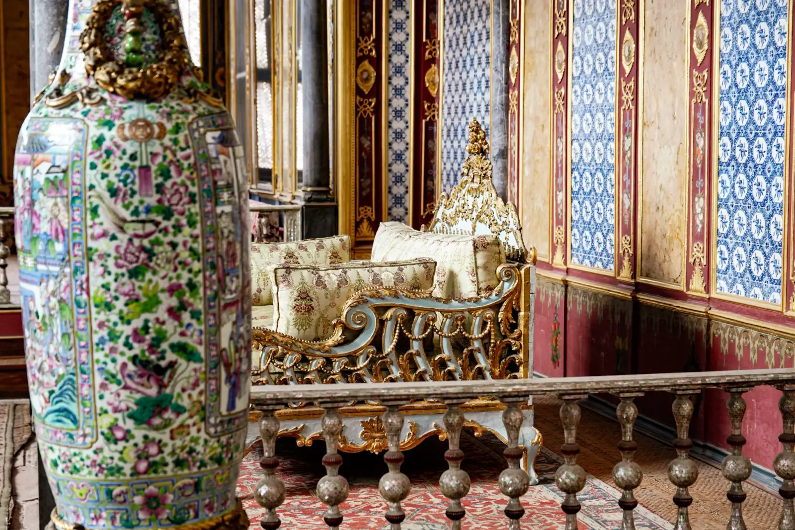 The sultan's raised seat in the Imperial Hall, a Chinese vase beside the balustrade.