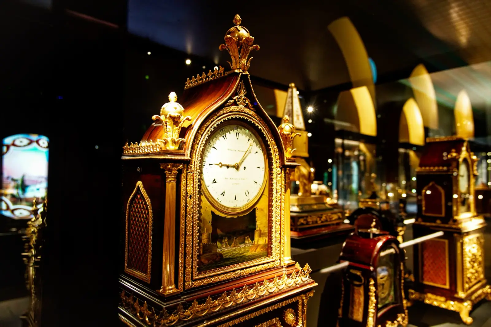 A gilded bracket clock made for the Ottoman court, its enamel dial lit in the case.