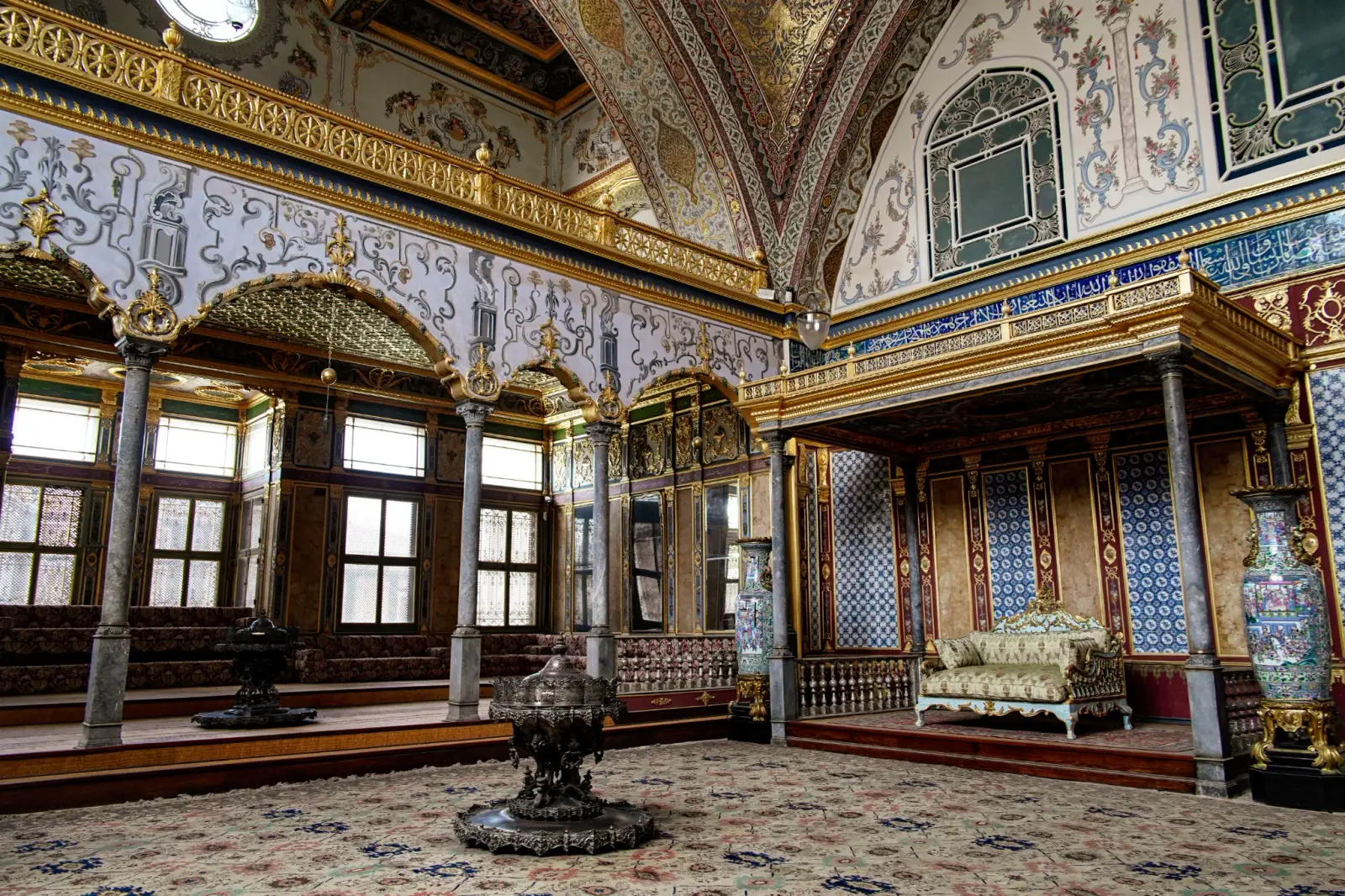 The Imperial Hall from the side: columns, tiled walls and the raised seat of the sultan.