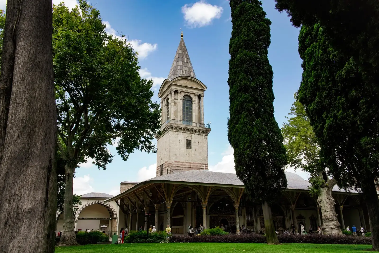 The Tower of Justice and the Council portico framed by tall cypresses.