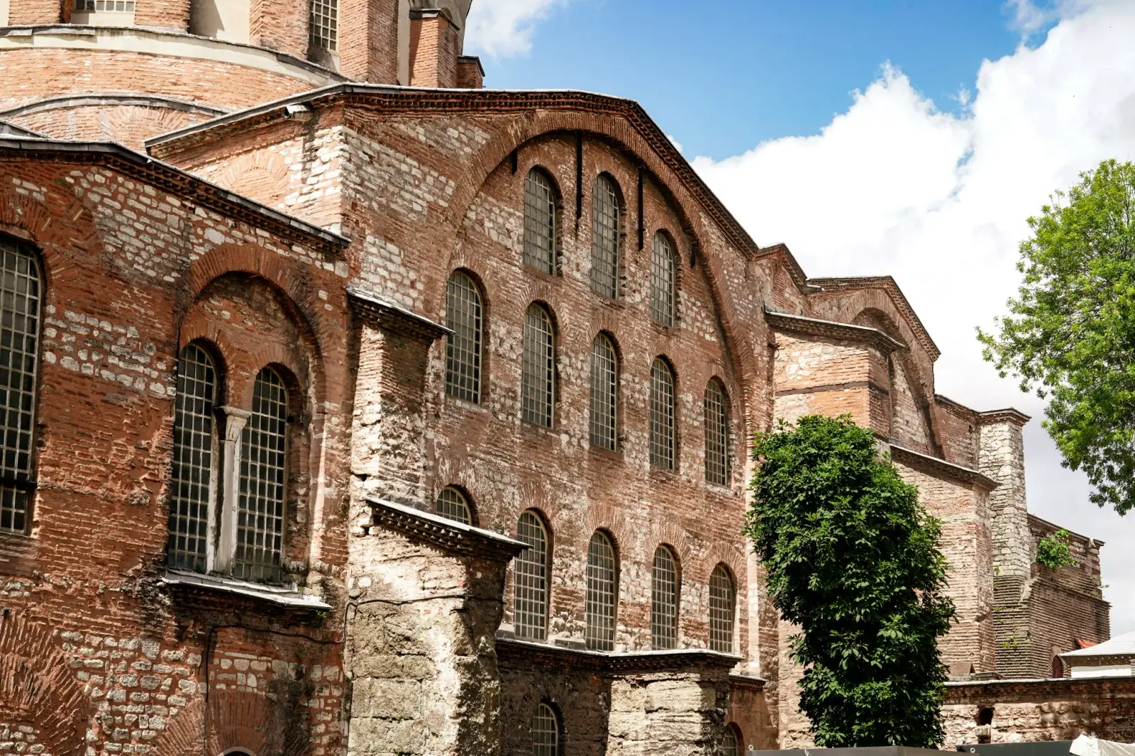 The banded brick and stone walls of Hagia Irene and its tall arched windows.