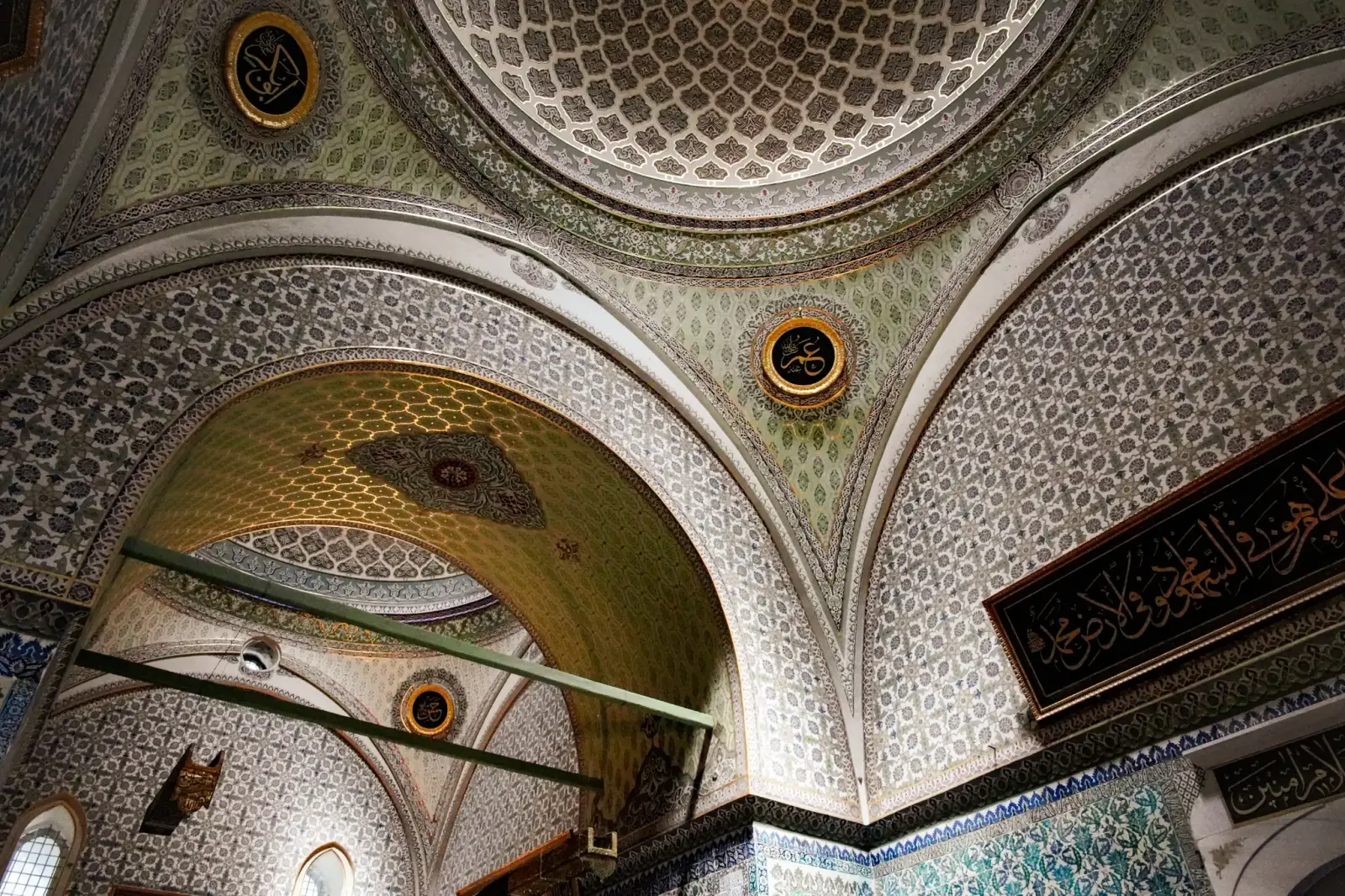 The painted and inscribed domes and muqarnas of the Privy Chamber.