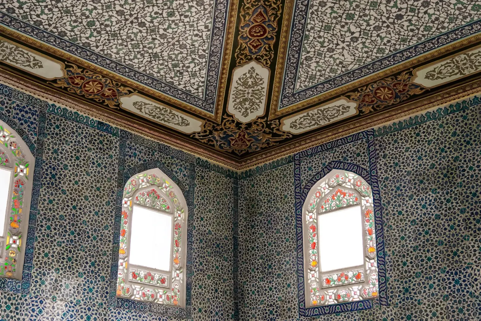 The tiled interior of the Circumcision Room, arched windows set in İznik panels.