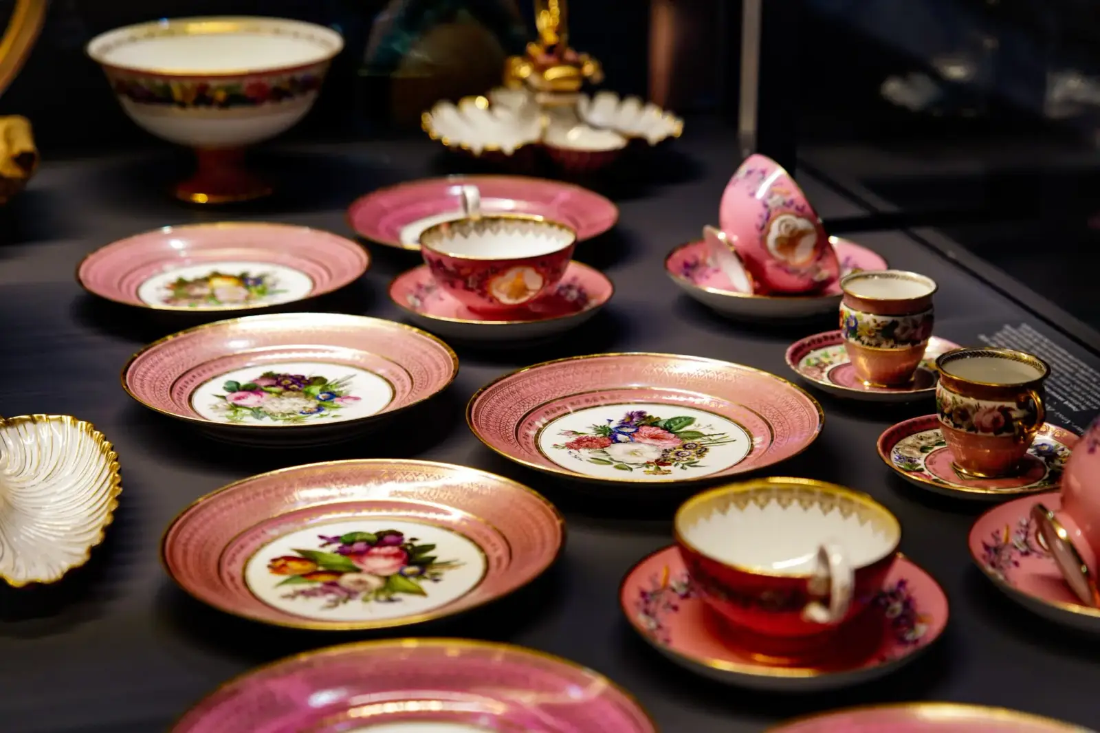 Pink floral European porcelain — plates, cups and saucers — in the palace collection.