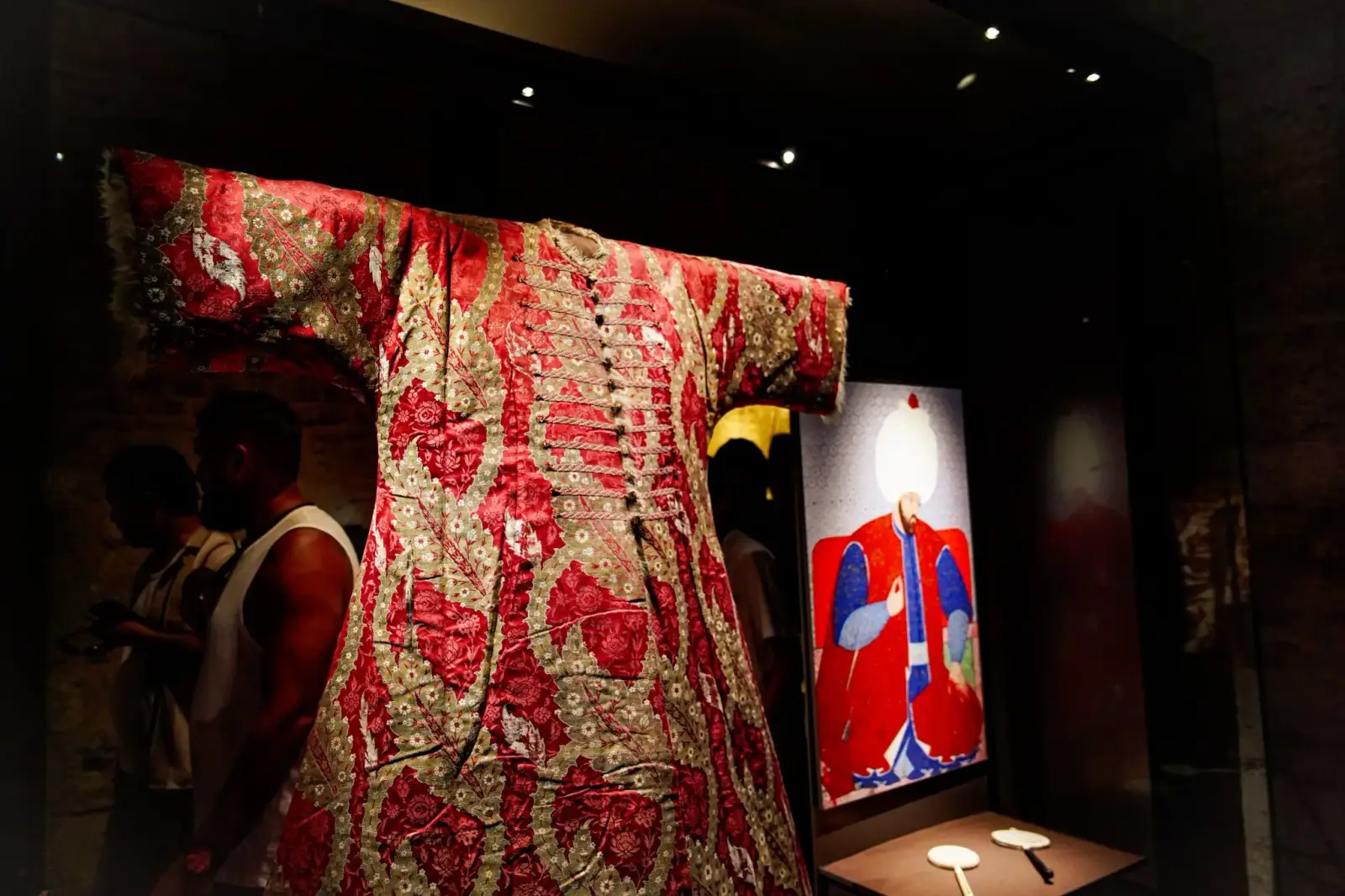 Imperial kaftans on display in the Expeditionary Force Ward, visitors in front of them.