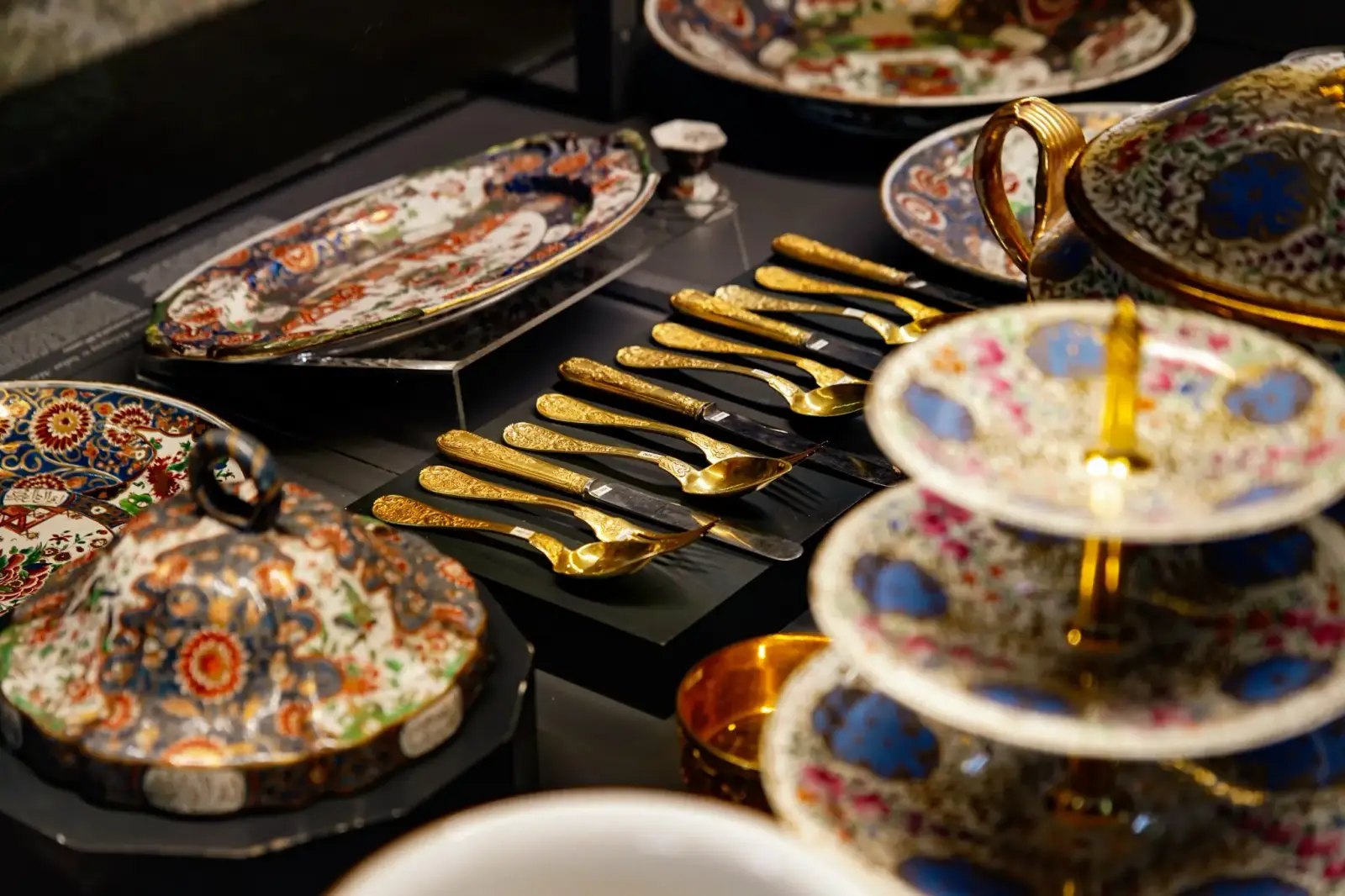 A European table service in the palace collection: gilded cutlery, tiered stands and painted plates.