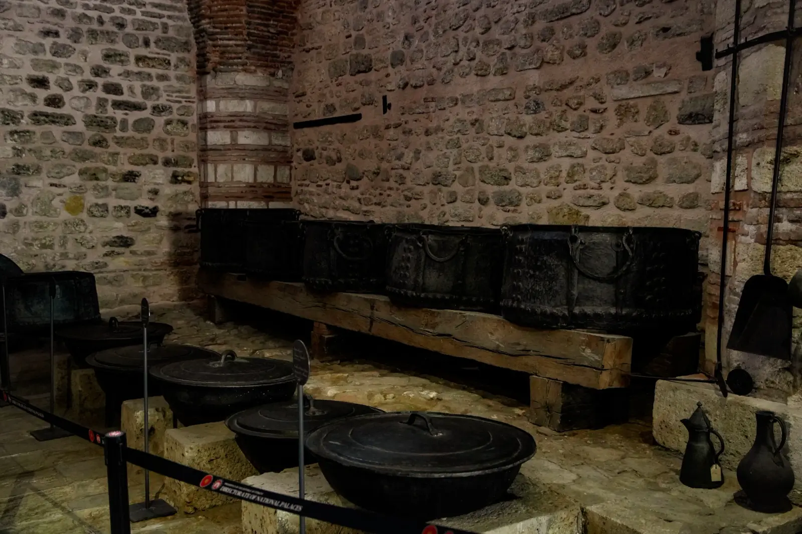 Cauldrons and iron-bound chests in the Palace Kitchens, where meals were prepared for thousands.